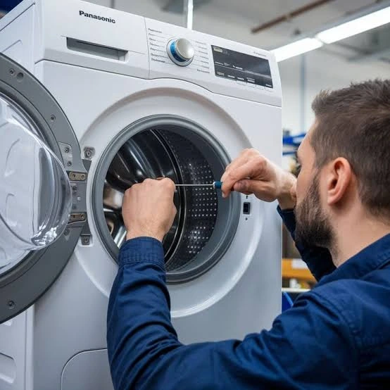 Technician checking the drum of a front-loading washing machine